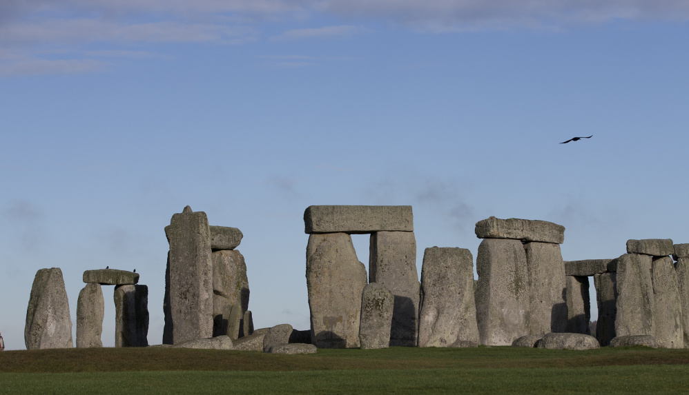 Associated Press/Alastair Grantf
Visitors take photographs of the World Heritage Site at Stonehenge, England. The two-lane road to the ancient monument is frequently jammed with traffic, so there are plans in the works to alleviate congestion.