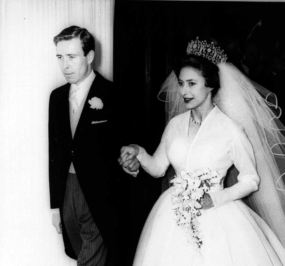 Anthony Armstrong-Jones, future Earl of Snowdon, holds the hand of his bride, Princess Margaret, as they leave London's Westminster Abbey after their 1960 wedding.