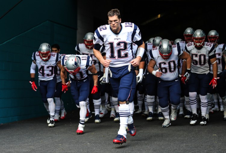 Tom Brady leads the Patriots onto the field to face the Miami Dolphins on Jan. 1. Don't tell him that the Patriots will roll over the Texans in Saturday night's playoff game.