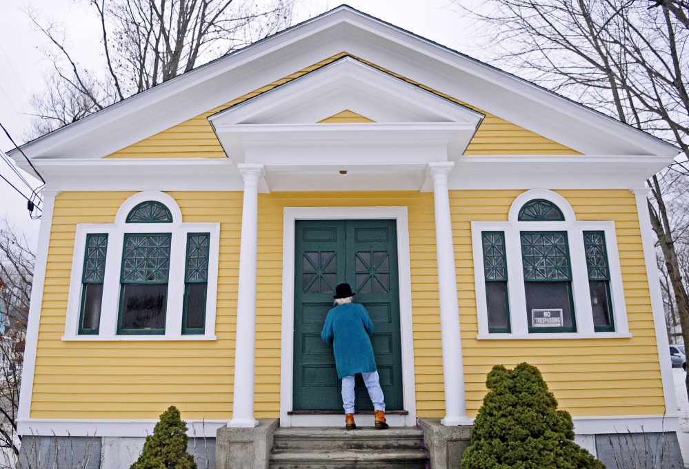 Shelia Sanford unlocks the front doors Thursday at the North Monmouth Library.