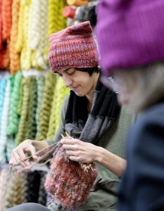Casey Ryder, owner of PortFiber, knits a hat for the Pussyhat Project on Thursday. The hats will be worn by women at protest marches in Washington and elsewhere on Jan. 21, the day after the inauguration of Donald Trump as the 45th president.