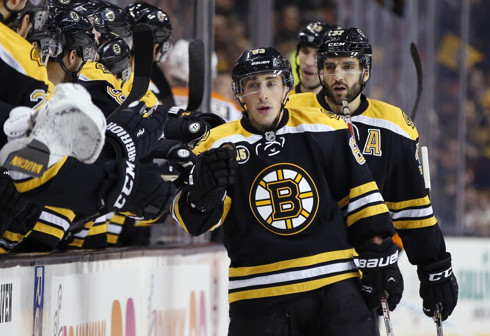 Boston's Brad Marchand celebrates his first-period goal during Saturday's 6-3 win over the Philadelphia Flyers in Boston Marchand finished with two goals and three assists. (Associated Press/Michael Dwyer)