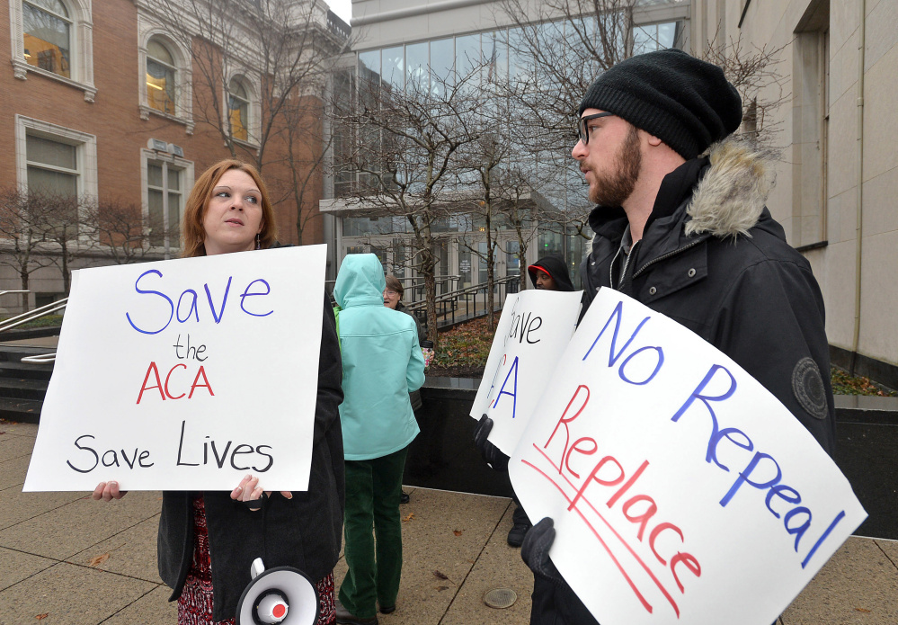 Protesters at the Federal Courthouse in Erie, Pa., deliver signatures on a petition urging U.S. Sen. Pat Toomey, R-Pa., not to repeal the Affordable Care Act without a replacement. Christopher Millette/Erie Times-News via AP)