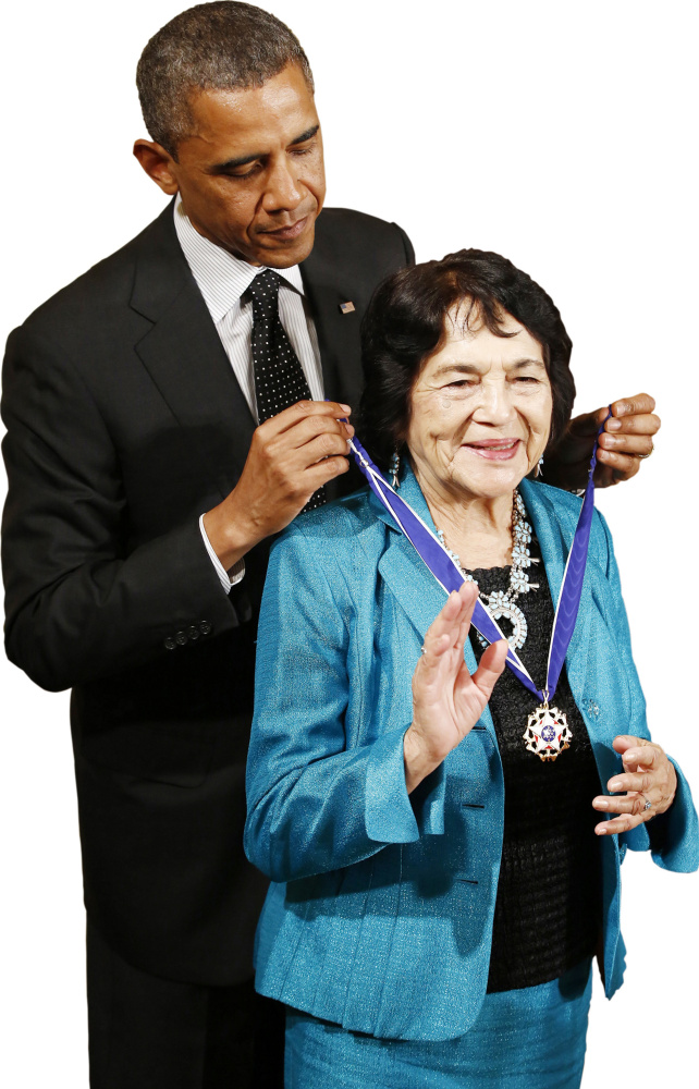 President Obama awards Dolores Huerta, co-founder of the United Farm Workers, the Presidential Medal of Freedom in 2012. Her group coined the "Yes we can" slogan – in Spanish.