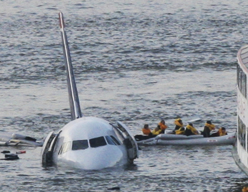 In this Jan. 15, 2009, photo, passengers in an inflatable raft move away from an Airbus 320 US Airways aircraft that went down in the Hudson River in New York. Bird interference was blamed for the accident. (Associated Press/Bebeto Matthews)