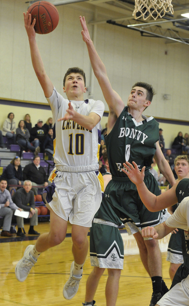 Will Shibles of Cheverus drives to the basket against Bonny Eagle's Zach Maturo during their Class AA basketball game Saturday in Portland. Cheverus won, 51-43.