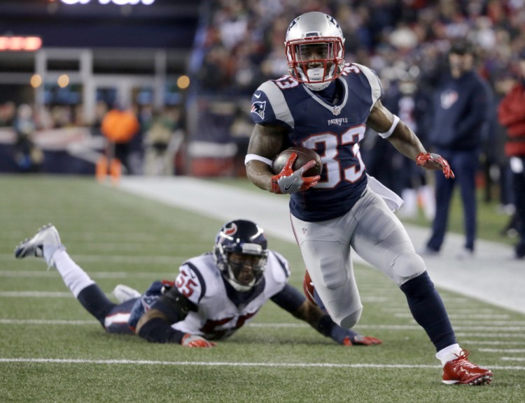 Patriots running back Dion Lewis leaves Houston's Benardrick McKinney in his wake on the way to the first of three touchdowns Saturday night in the AFC playoffs at Gillette Stadium. The Patriots won, 34-16.