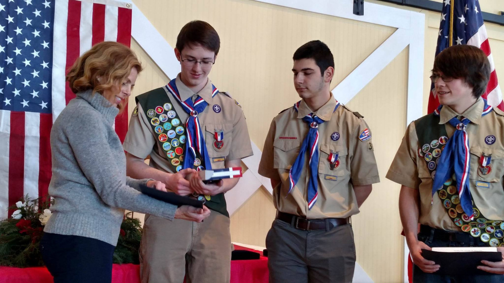 Sen. Amy Volk, R-Dist. 30, presents Boy Scouts Jacob Murphy, Joshua Passarelli and John Hinkle with Maine state flags that were flown over the State House. The presentation was made to honor their achievement in attaining the rank of Eagle Scout. All three scouts are from Scarborough and members of Troop 39.
