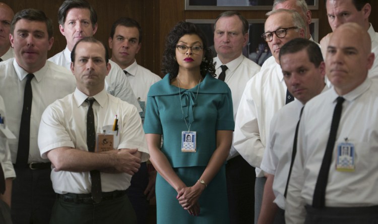 Katherine Johnson, played by Taraji P. Henson, listens with her white male colleagues in a scene from "Hidden Figures."