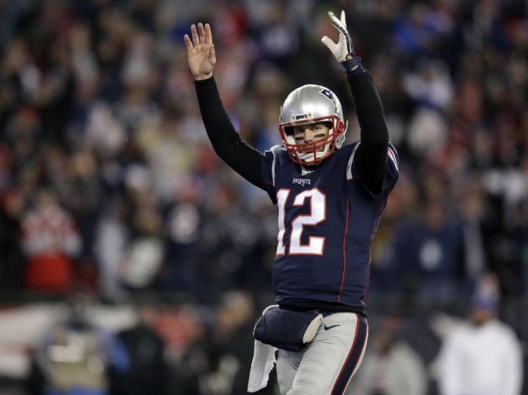 New England Patriots quarterback Tom Brady celebrates a touchdown by running back Dion Lewis during the  divisional playoff game  against the Houston Texans.