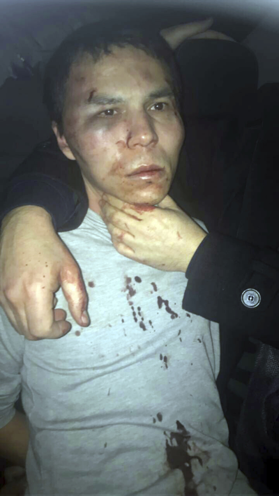 The first published image of the suspect shows a bruised, black-haired man in a bloodied shirt being held by his neck. NTV television said the man had resisted arrest. Turkish media have identified the nightclub gunman as Abdulkadir Masharipov, an Uzbekistan national.