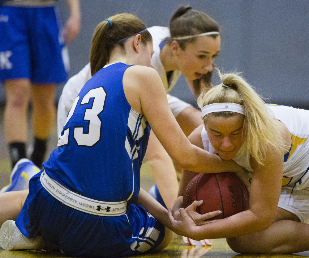 Kennebunk's Madison Lux, left, and Falmouth's Grace Soucy wrestle for the ball during the Yachtsmen's 41-31 win Monday in Falmouth. Soucy scored 10 points to help Falmouth improve to 6-6.