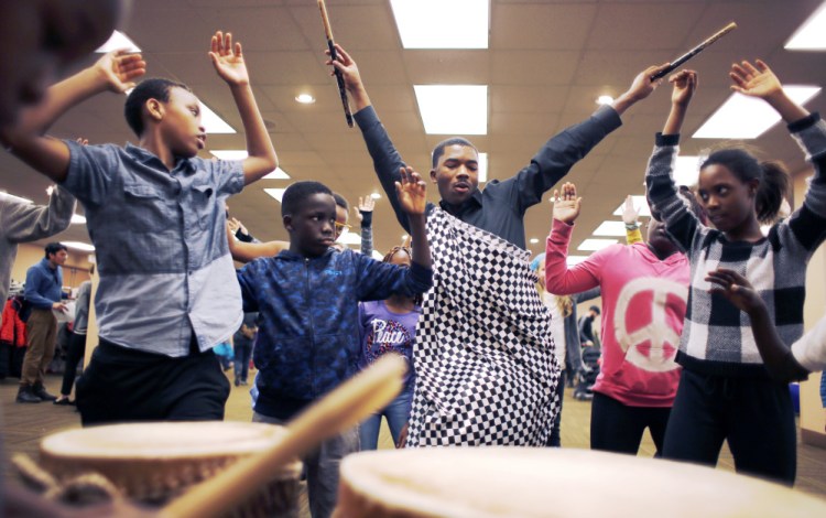 Maurice Habimfura leads children in Rwandan dance lessons Monday during the MLK Day Family Celebration at the Holiday Inn by the Bay in Portland. The event sought to explore Martin Luther King Jr.'s ideals of equality and freedom through the arts, music, poetry and more.