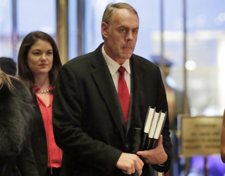 Interior Secretary-designate Rep. Ryan Zinke, right, R-Mont., says he would never sell, give away or transfer public lands, a crucial stance in his home state of Montana and the West, where access to hunting and fishing is considered sacrosanct.