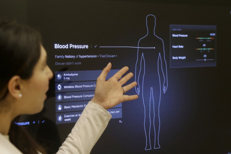 Dr. Aaliya Yaqub demonstrates a medical checkup at a Forward medical office in San Francisco. The Forward health-management service costs $149 per month and uses high-tech devices to gather information.