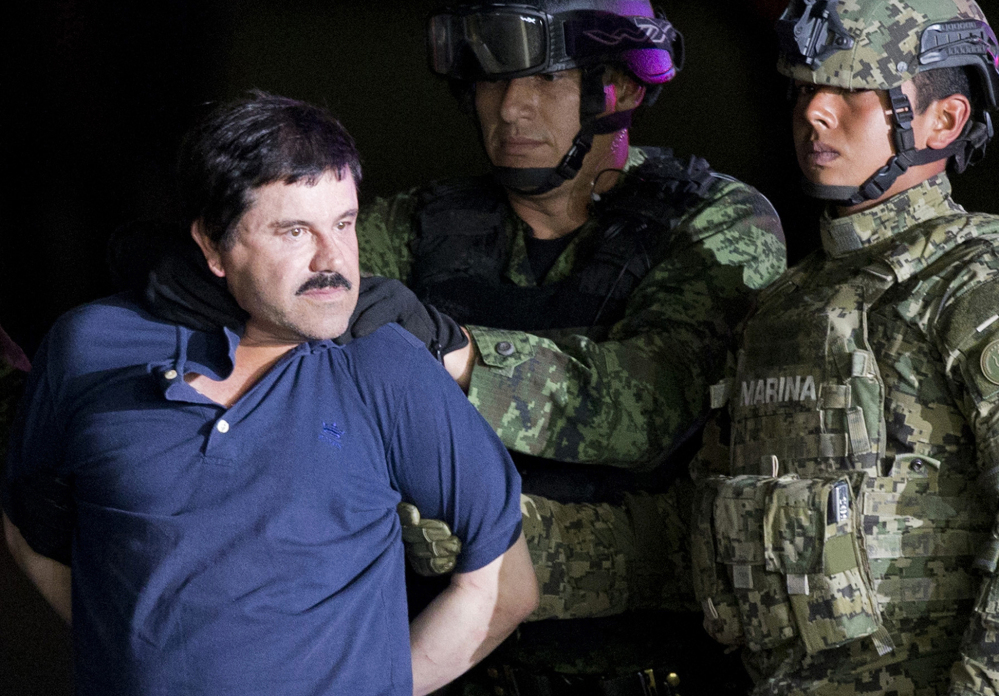 Joaquin "El Chapo" Guzman is escorted to a helicopter by Mexican soldiers and marines at a federal hangar in Mexico City in 2016. Mexico's most notorious cartel kingpin was extradited to the United States on Thursday to face drug trafficking and other charges.
Associated Press