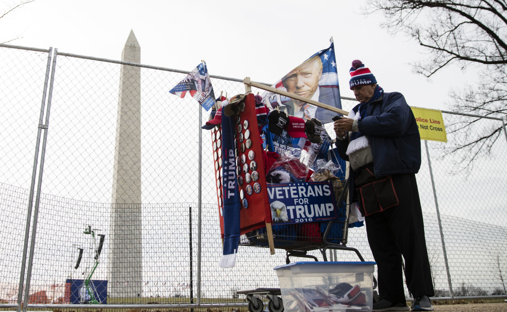A vendor waits for customers to buy his wares near the Washington Monument in Washington on Thursday, ahead of Friday's presidential inauguration ceremony for Donald Trump.