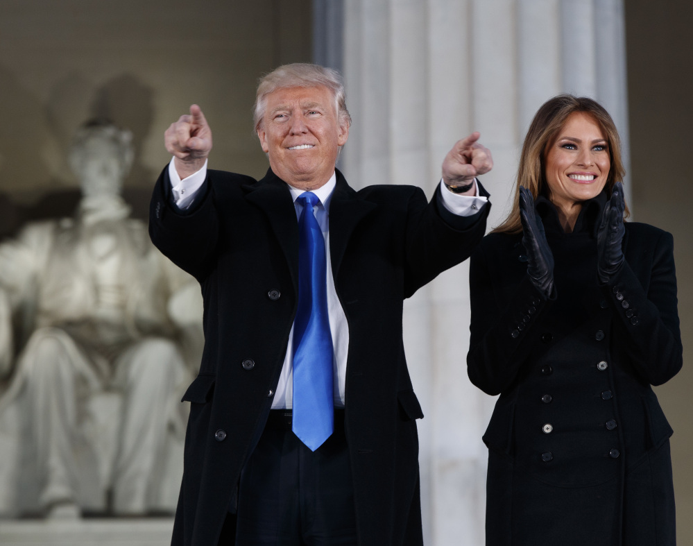 President-elect Donald Trump, left, and his wife Melania Trump arrive to the pre-inauguration concert at the Lincoln Memorial on Thursday night in Washington.