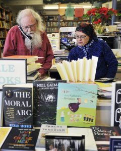 Lawless and his wife Beth Leonard work behind the counter together at their book store. 