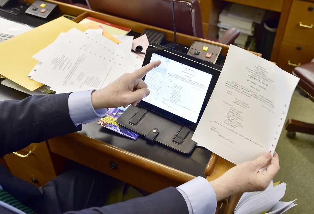 Barry Hobbins, State Rep for district 14 serving Saco, enjoys his iPad getting all the documents and calendars at a moments touch over the seemingly archaic mass of paper prints of those same documents, according to Representative Hobbins. Gordon Chibroski/Staff Photographer