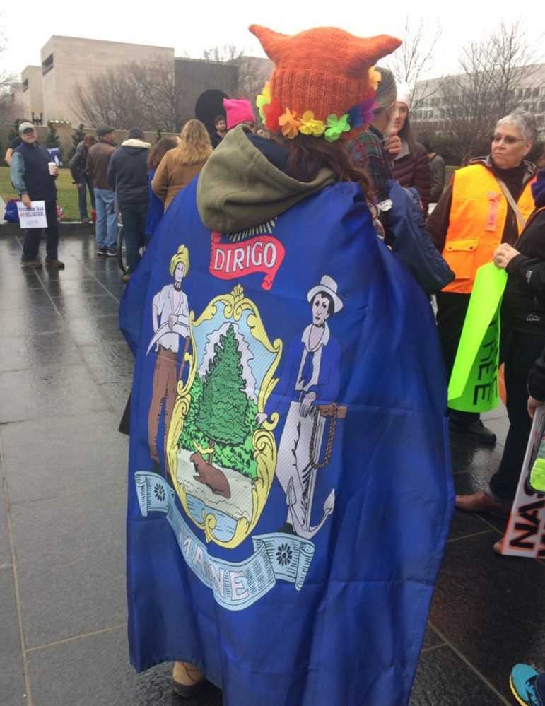 A marcher wears a Maine state flag near the National Mall before the Women's March on Washington.
