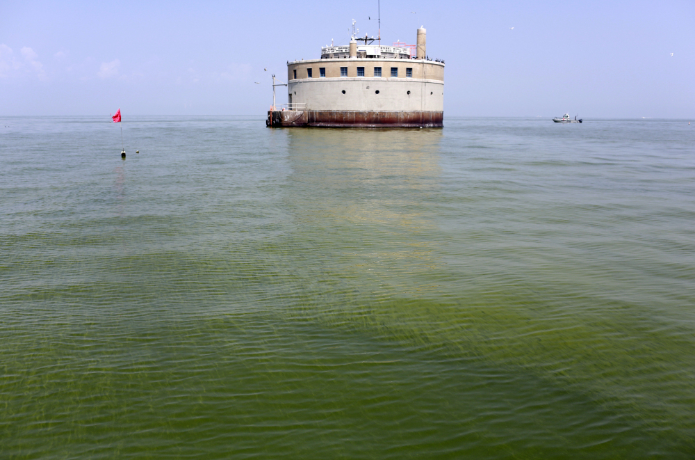 The water intake crib for the city of Toledo, Ohio, is surrounded by an algae bloom on Lake Erie in August 2014. As of early 2017, about 12,000 farmers and fertilizer applicators have completed Ohio's three-hour training program that soon will be required to use commercial fertilizer. The first-of-its-kind requirement, approved by Ohio lawmakers in 2014, is one step the state has taken to reduce farm runoff that feeds toxic algae in lakes and rivers.