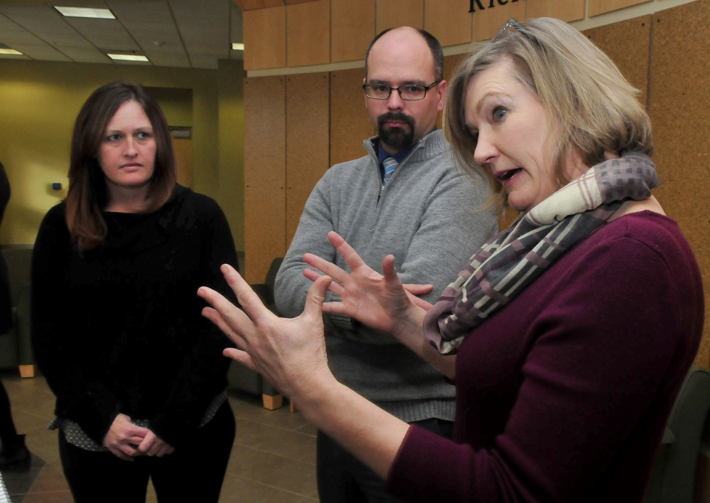 University of Maine Farmington professor Kelly Bentley, right, speaks Monday with Tricia Plourde and Ryan Goding of Western Maine Homeless Outreach shelter about the work her studenrs performed to gain a $5,000 grant from Skowhegan Savings Bank for the shelter.