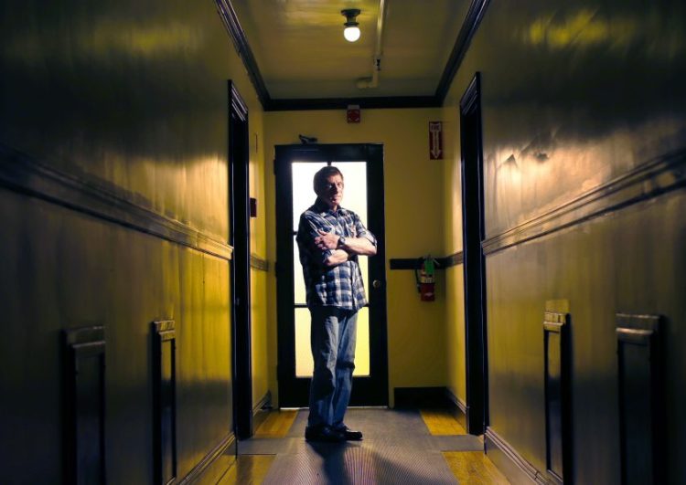 Jenson Steel, a longtime HIV patient at the India Street clinic who helped others transition to a new health care provider, stands in the corridor outside his West End apartment. The directed transfer of patients to a new facility caused "emotional trauma," said Steel, 67.