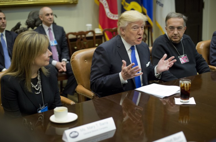 GM chief executive Mary Barra, left, and Fiat Chrysler Automobiles CEO Sergio Marchionne, right, listen Tuesday to President Trump at the start of a meeting with automobile leaders at the White House. Trump said his administration will keep "real regulations that mean something" but curtail those he believes hamper business.