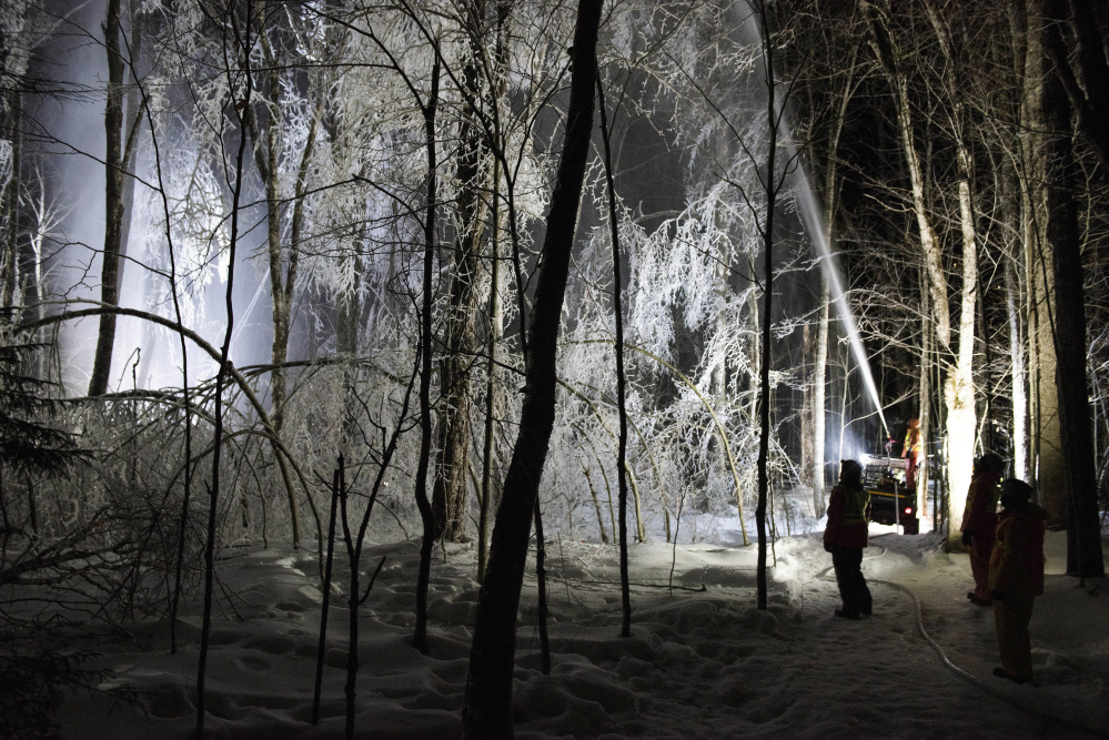 A firefighting hose mounted on an ATV sprays water on trees in the Hubbard Brook Experimental Forest in Woodstock, New Hampshire.