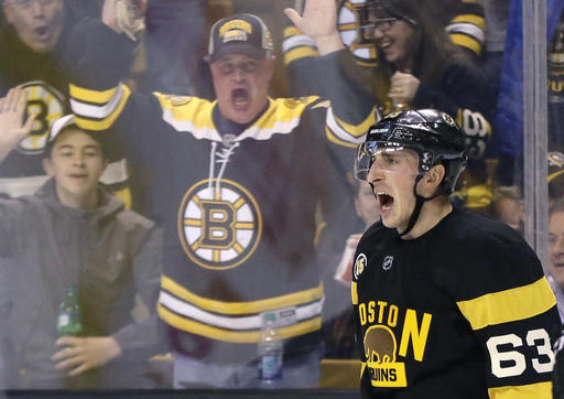 Fans cheer along with Bruins left wing Brad Marchand after his second-period goal Thursday night against the Penguins in Boston. The comeback win was the second straight for the Bruins, but they haven’t had what amounts to a hot streak in months and will have to finish strong to make the playoffs.