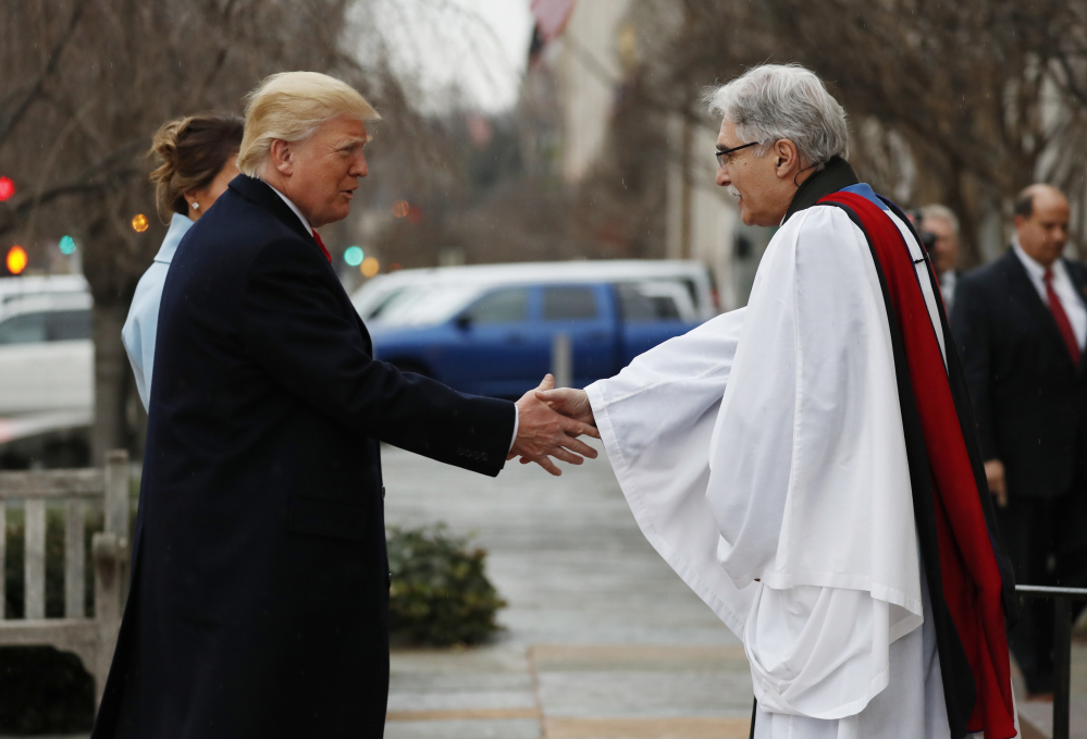Rev Luis Leon greets President-elect Donald Trump and his wife Melania as they arrive for a church service at St. John's Episcopal Church across from the White House in Washington, Friday, Jan. 20, 2017, on Donald Trump's inauguration day. (AP Photo/Alex Brandon)