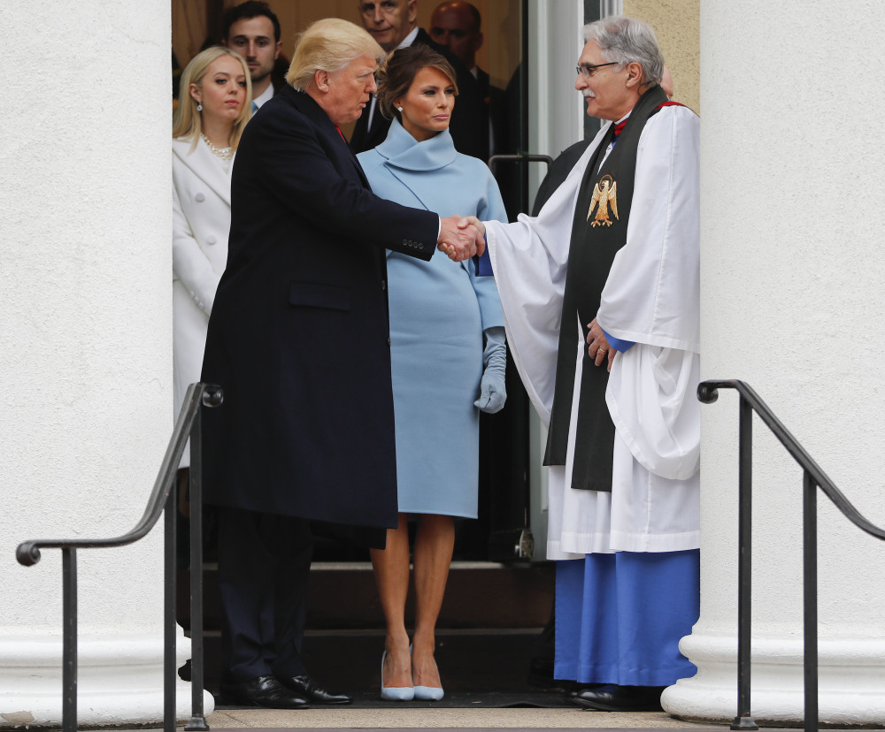 President-elect Donald Trump, accompanied by his wife Melania, shake hands with Rev. Luis Leon after attending church service at St. John's Episcopal Church across from the White House in Washington, Friday, Jan. 20, 2017. (AP Photo/Pablo Martinez Monsivais)