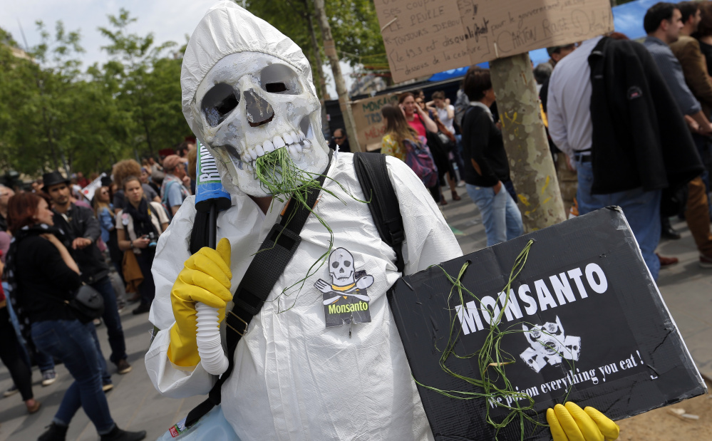 A protester takes part in a demonstration against Monsanto last year in Paris, where European researchers have raised concern about the weed-killer Roundup. A judge ruled that California can require Monsanto product Roundup to carry a cancer warning label.