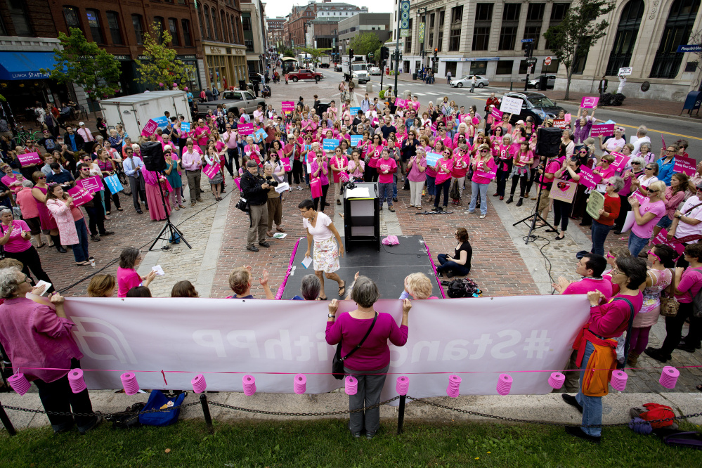 Eliza Townsend of the Maine Women's Lobby finishes speaking at a rally for Planned Parenthood in Portland's Monument Square in September. Republicans are seeking to fold defunding Planned Parenthood into repeal of the ACA.