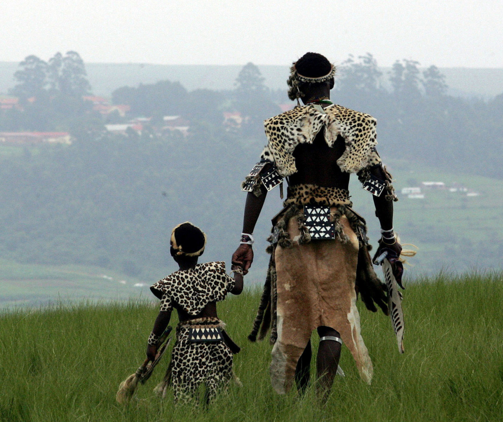 Dressed in tribal leopard skins, a man and his son, members of the Shembe church, embark on a pilgrimage last year near the city of Durban in South Africa.