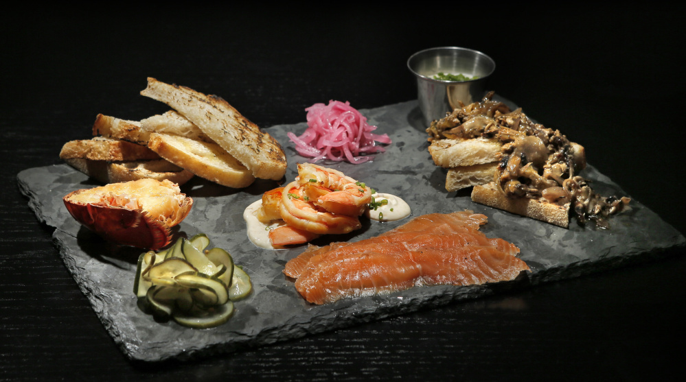 A smoked & cured board, including mussels escabeche, spicy shrimp, smoked lobster tail and salmon at Row 34.
