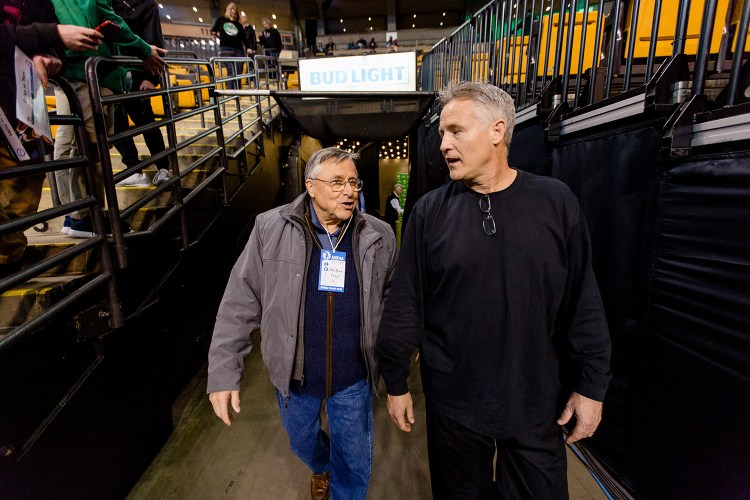 Bob Brown, left, of Scarborough walks out of the tunnel at TD Garden in Boston with his son Brett, coach of the Philadelphia 76ers.
