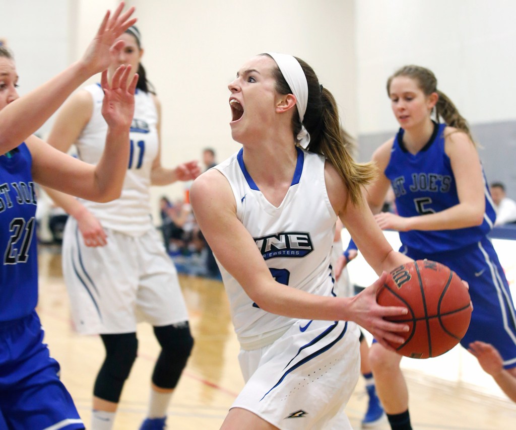 Ashley Coneys of UNE drives to the basket in the first quarter of Monday night's game in Biddeford.