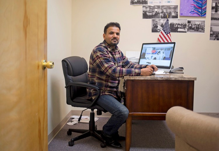 Faysal Kalayf, working in his office as vice president of the Iraqi Community Association of Maine, says immigrants are calling to ask how President Trump's actions will affect their legal status and loved ones.