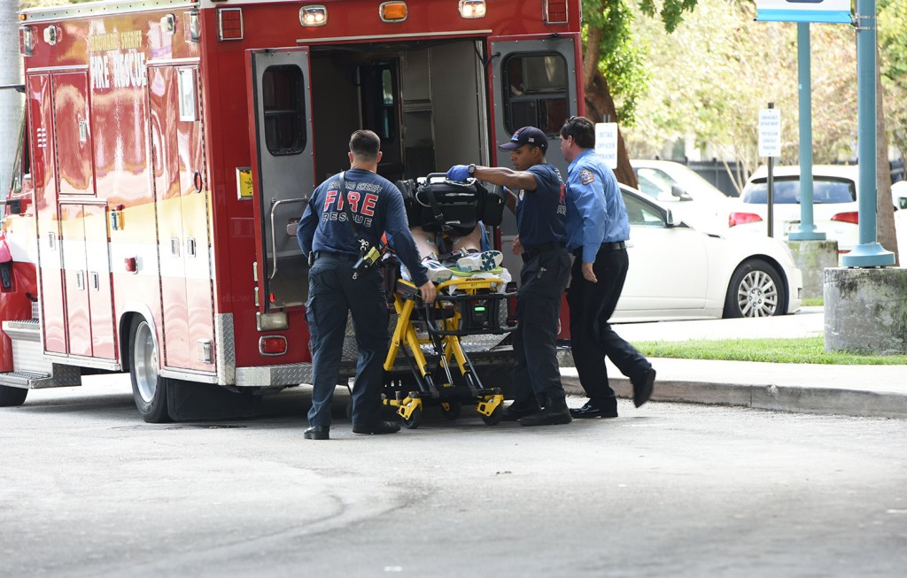 A victim of Friday's shootings is unloaded from an emergency vehicle and taken into Broward Health Trauma Center in Fort Lauderdale, Fla.
Taimy Alvarez /South Florida Sun-Sentinel via AP