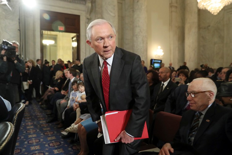 Attorney General-designate Sen. Jeff Sessions, R-Ala., takes his seat Tuesday before his confirmation hearing before the Senate Judiciary Committee. Former Attorney General Michael Mukasey is at right. <em>Associated Press/Andrew Harnik</em>
