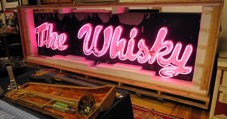 A marquee from the legendary Whisky a Go Go glows at the Saco River Auction Co. in Biddeford, where it sold Wednesday night for $43,000.