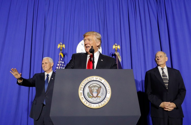 President Trump, accompanied by Vice President Mike Pence, left, and Homeland Security Secretary John F. Kelly, speaks at the Homeland Security Department in Washington on Wednesday.