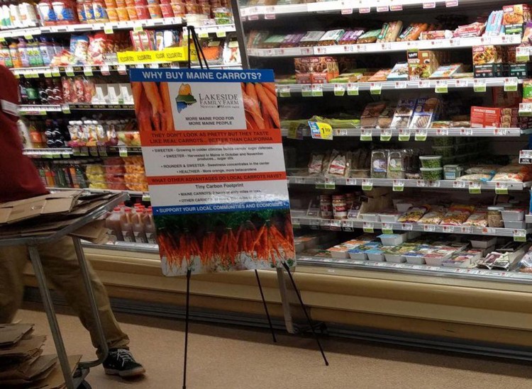 A poster at Hannaford promotes a local farmer's taste test experiment pitting Maine carrots against those from California.