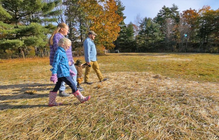 Walter and Aaron Morse, with their children Paige and Joseph, walk through a field at their Patriot Ridge Homestead in Jefferson. The family will be featured Sunday on the first episode of a new a television show called "Growing Home," about veterans working in agriculture throughout Maine. <em>Photo courtesy of Up Country Productions</em>