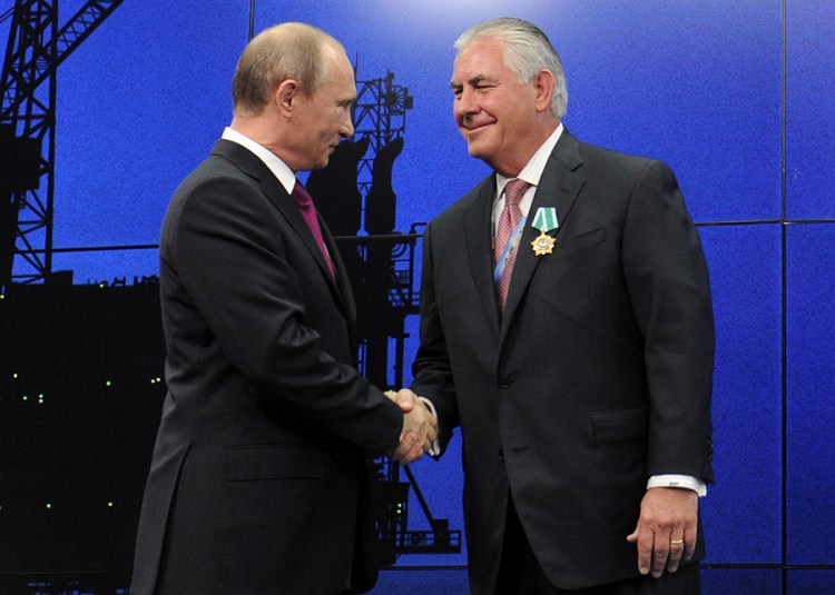 Those were the days: Russian President Vladimir Putin shakes hands with Exxon Mobil Chief Executive Rex Tillerson during a ceremony awarding medals to heads and employees of major energy companies, in St. Petersburg, on June 21, 2013. 