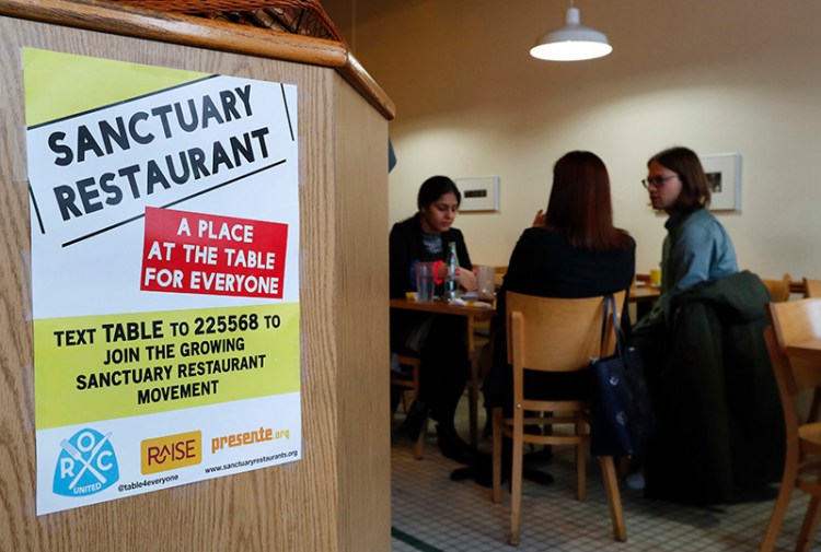 A sanctuary restaurant sign is shown inside Russell Street Deli in Detroit. 