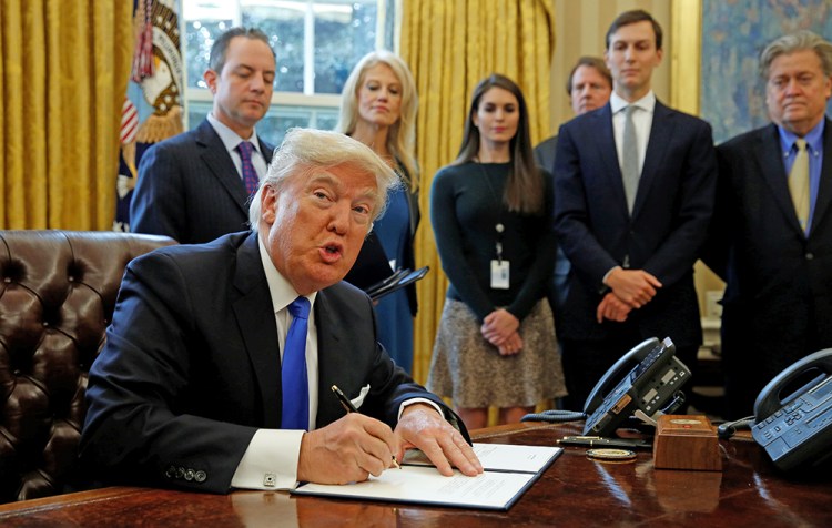 President Donald Trump signs an executive order to advance construction of the Keystone XL pipeline at the White House Tuesday. 