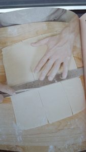 This image from "Making Dough" illustrates how to cut a 9" by 12" rectangle of shortcrust dough into nine 3" by 4" Pop-Tart shells. The recipe is doubled to make tops and bottoms.